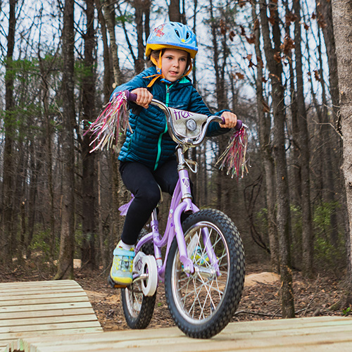 Young girl riding bike on the Touch of Nature Kids Terrain Track