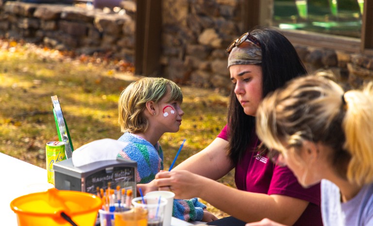 Three people painting at haunted hollow