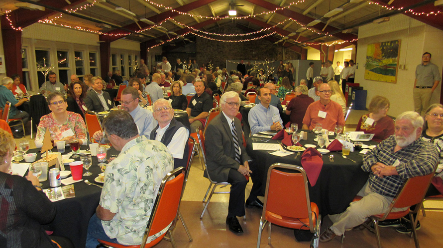 large group of people sitting at tables and eating